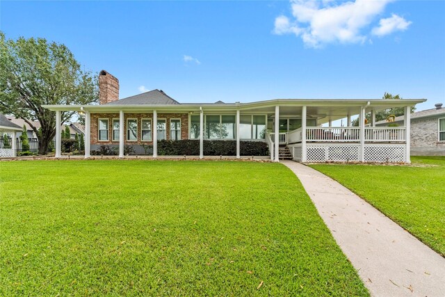 466 Buffalo Ct, Livingston, TX 77351 - rear view of house with brick siding, a lawn, a chimney, and covered porch