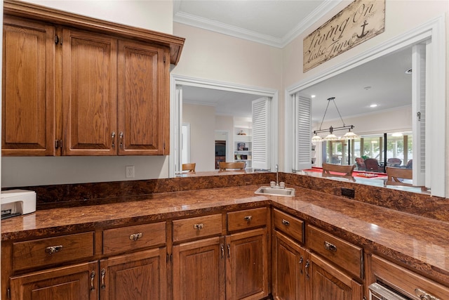 466 Buffalo Ct, Livingston, TX 77351 - kitchen featuring a sink, brown cabinets, and crown molding