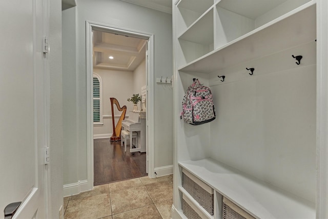 21603 Fairhaven Creek Dr, Cypress, TX 77433 - mudroom with coffered ceiling, baseboards, light tile patterned flooring, crown molding, and beamed ceiling