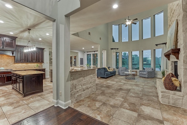 21603 Fairhaven Creek Dr, Cypress, TX 77433 - living area with ceiling fan, recessed lighting, a fireplace, and a high ceiling