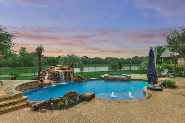 21603 Fairhaven Creek Dr, Cypress, TX 77433 - pool at dusk featuring a fenced backyard, a patio, and a pool with connected hot tub
