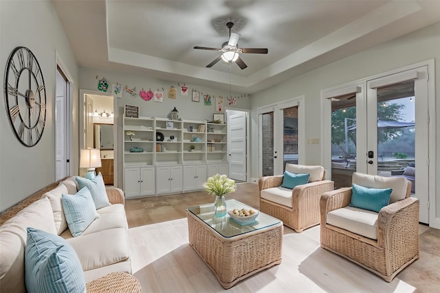 21603 Fairhaven Creek Dr, Cypress, TX 77433 - living room featuring a tray ceiling, a ceiling fan, and french doors