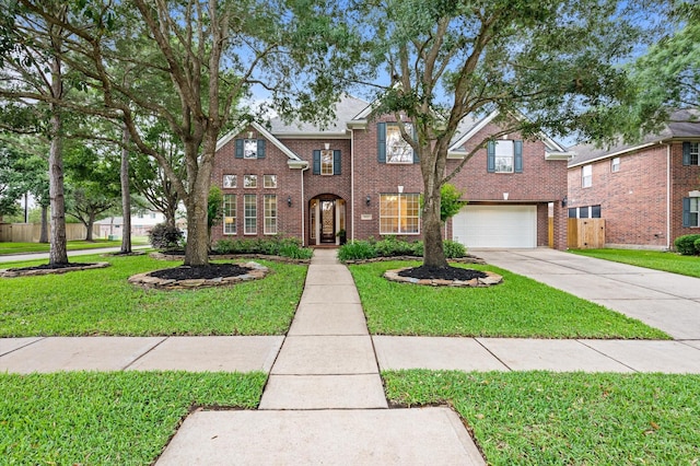 traditional home featuring fence, brick siding, a garage, a front yard, and driveway