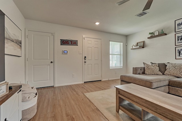 living room with a ceiling fan, light wood-style flooring, baseboards, visible vents, and recessed lighting