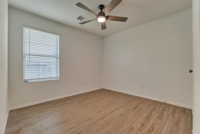 unfurnished room featuring a ceiling fan, light wood-style floors, visible vents, and plenty of natural light