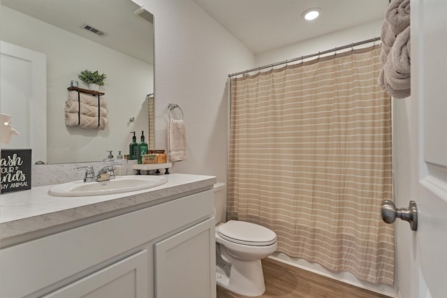 full bath featuring wood finished floors, vanity, toilet, visible vents, and recessed lighting