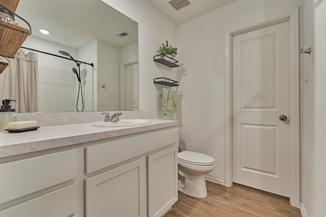 155 Pine Bend Ct, Magnolia, TX 77354 - bathroom with toilet, vanity, wood finished floors, curtained shower, and recessed lighting