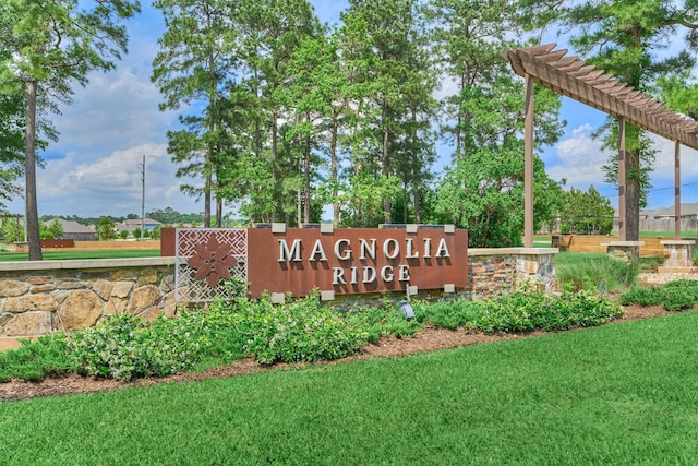 community / neighborhood sign with a lawn