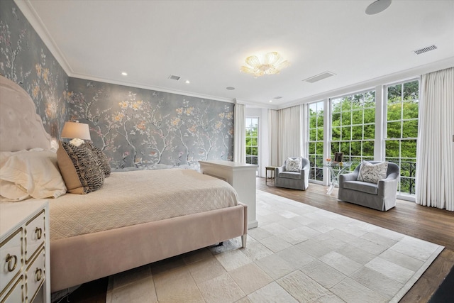 bedroom with visible vents, crown molding, and wallpapered walls