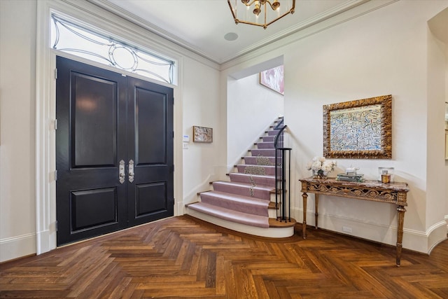 foyer entrance with ornamental molding, stairs, and baseboards