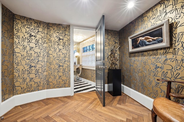interior space featuring wallpapered walls and baseboards