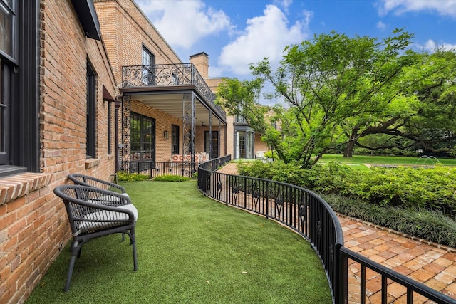 view of yard with a balcony
