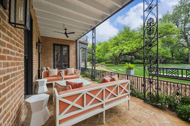view of patio / terrace with an outdoor living space, a ceiling fan, and french doors