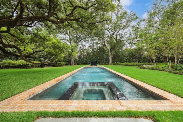 view of pool with a yard and an in ground hot tub