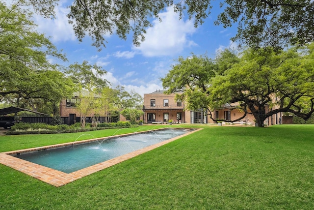 view of swimming pool with a yard