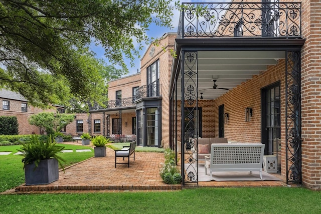 view of patio with a balcony and a ceiling fan