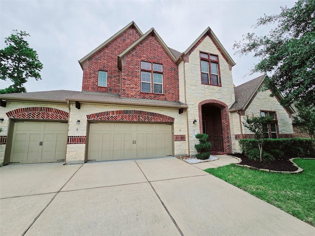 47 Chestnut Meadow Dr, Conroe, TX 77384 - view of front of house featuring brick siding, an attached garage, stone siding, and concrete driveway