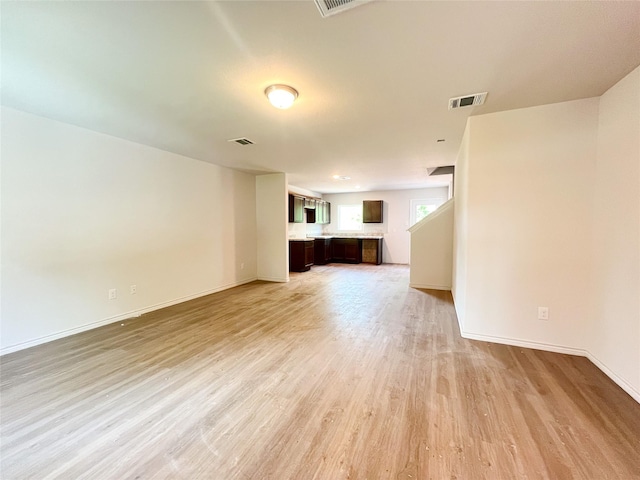 310 N Orange St, Sweeny, TX 77480 - unfurnished living room with light wood-style floors and baseboards
