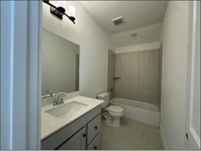 401 Wild Thicket Dr, Katy, TX 77493 - bathroom with vanity and shower / bathtub combination