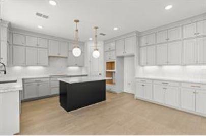 401 Wild Thicket Dr, Katy, TX 77493 - kitchen with recessed lighting, light countertops, decorative light fixtures, a kitchen island, and tasteful backsplash