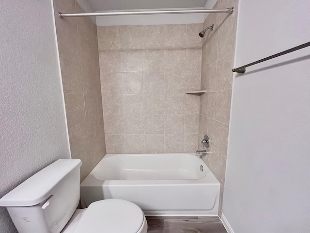 306 N Orange St, Sweeny, TX 77480 - bathroom with toilet, shower / bathtub combination, a textured wall, and wood finished floors