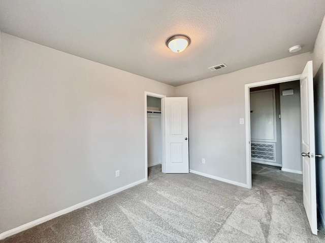 306 N Orange St, Sweeny, TX 77480 - unfurnished bedroom featuring carpet flooring, baseboards, a closet, and a textured ceiling