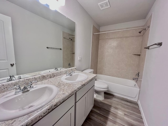 306 N Orange St, Sweeny, TX 77480 - bathroom with toilet, wood finished floors, bathing tub / shower combination, double vanity, and baseboards