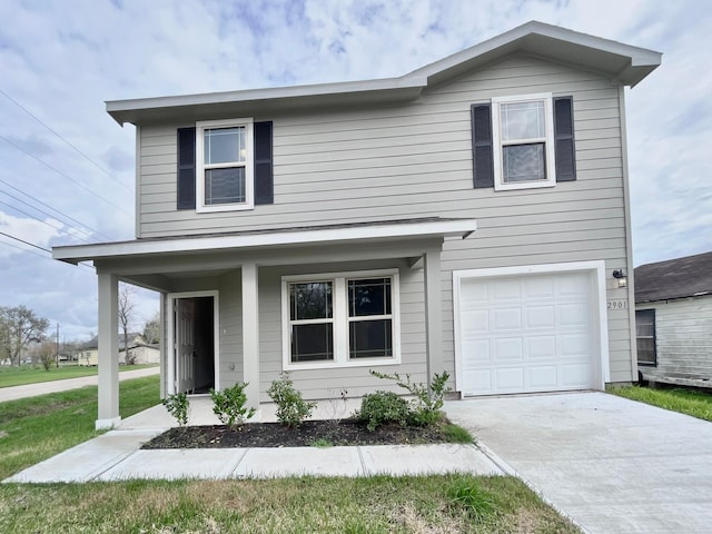 traditional home with covered porch, an attached garage, and concrete driveway