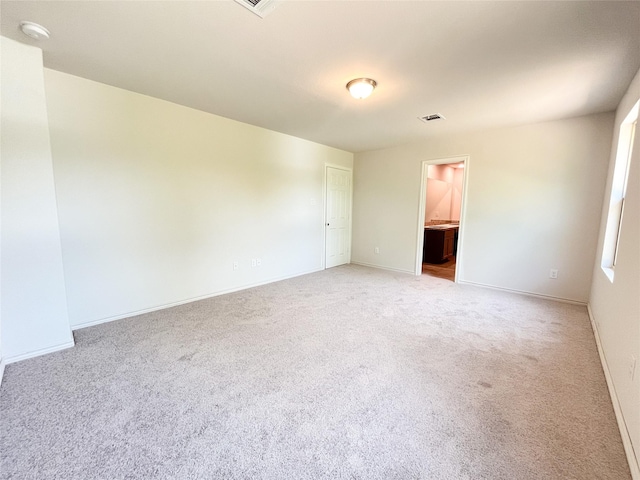 306 N Orange St, Sweeny, TX 77480 - spare room featuring light carpet, baseboards, and a smoke detector