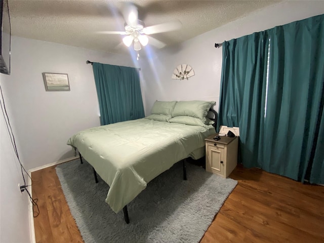 28604 Magnolia Ct, Huntsville, TX 77320 - bedroom featuring wood finished floors, a textured ceiling, and ceiling fan