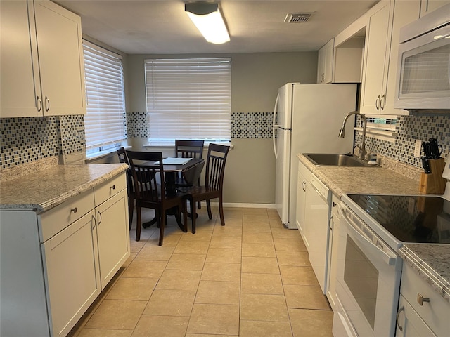 28604 Magnolia Ct, Huntsville, TX 77320 - kitchen featuring backsplash, light tile patterned flooring, a sink, and white appliances