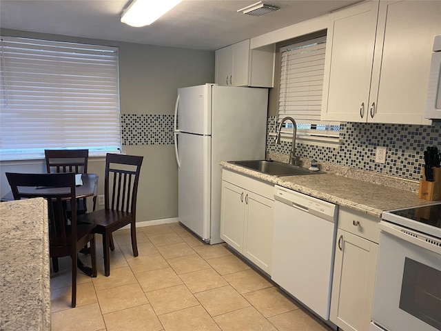 28604 Magnolia Ct, Huntsville, TX 77320 - kitchen featuring a sink, light tile patterned flooring, tasteful backsplash, visible vents, and white appliances