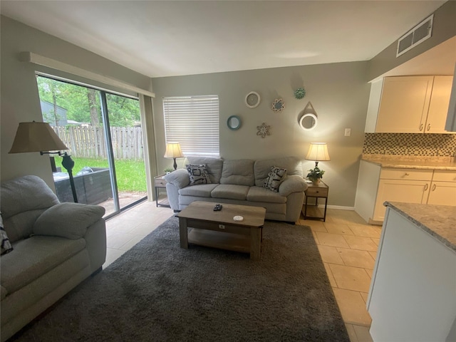 28604 Magnolia Ct, Huntsville, TX 77320 - living room with baseboards, visible vents, and light tile patterned floors