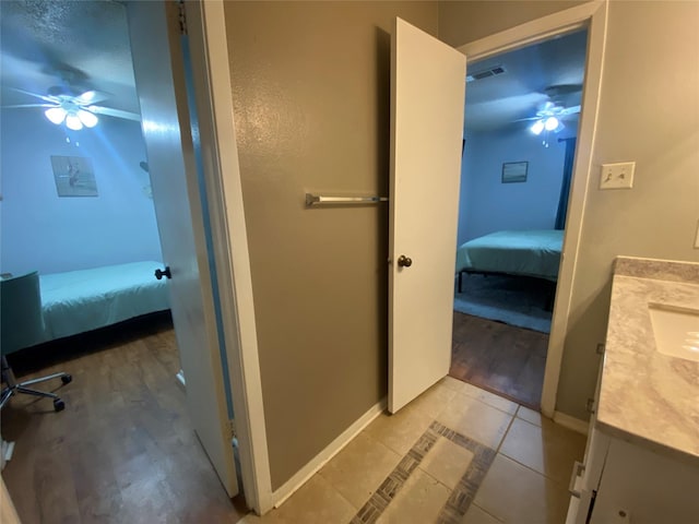 28604 Magnolia Ct, Huntsville, TX 77320 - bathroom with baseboards, ensuite bathroom, visible vents, and ceiling fan