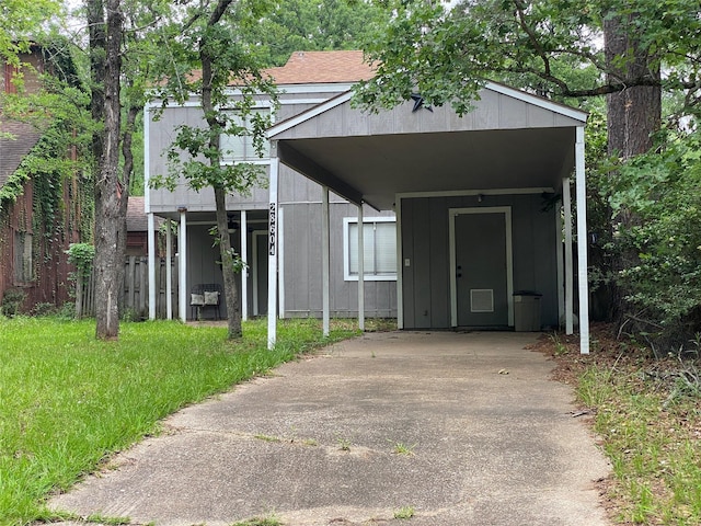 28604 Magnolia Ct, Huntsville, TX 77320 - view of front of home featuring concrete driveway and a carport