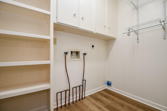 3339 Terry St, Needville, TX 77461 - clothes washing area featuring electric dryer hookup, cabinet space, wood finished floors, baseboards, and hookup for a washing machine