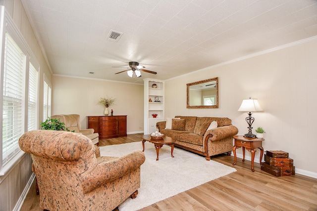 3339 Terry St, Needville, TX 77461 - living area with a healthy amount of sunlight, crown molding, light wood-style floors, and visible vents