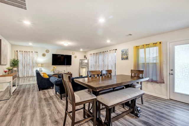 dining space with visible vents, recessed lighting, baseboards, and wood finished floors