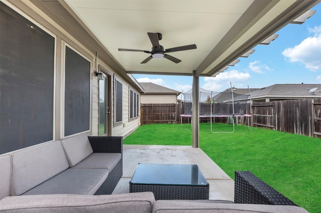 view of patio with a fenced backyard, a ceiling fan, a trampoline, and outdoor lounge area