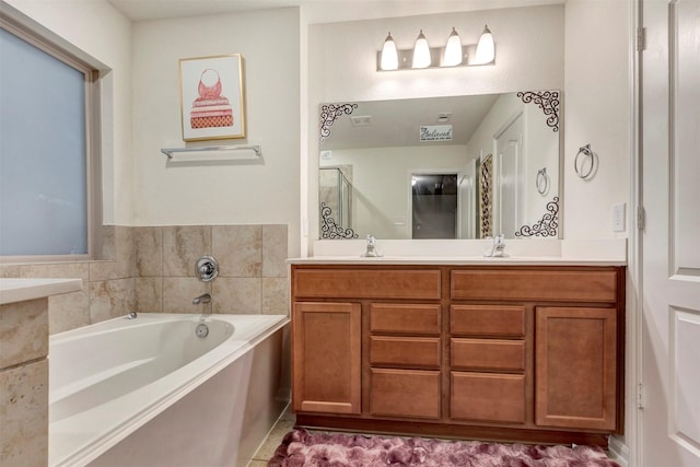 bathroom featuring double vanity, a sink, a bath, visible vents, and a shower stall