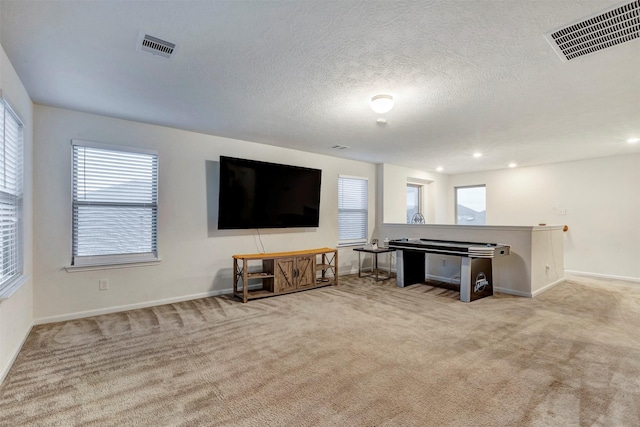 living room featuring visible vents, carpet, and baseboards