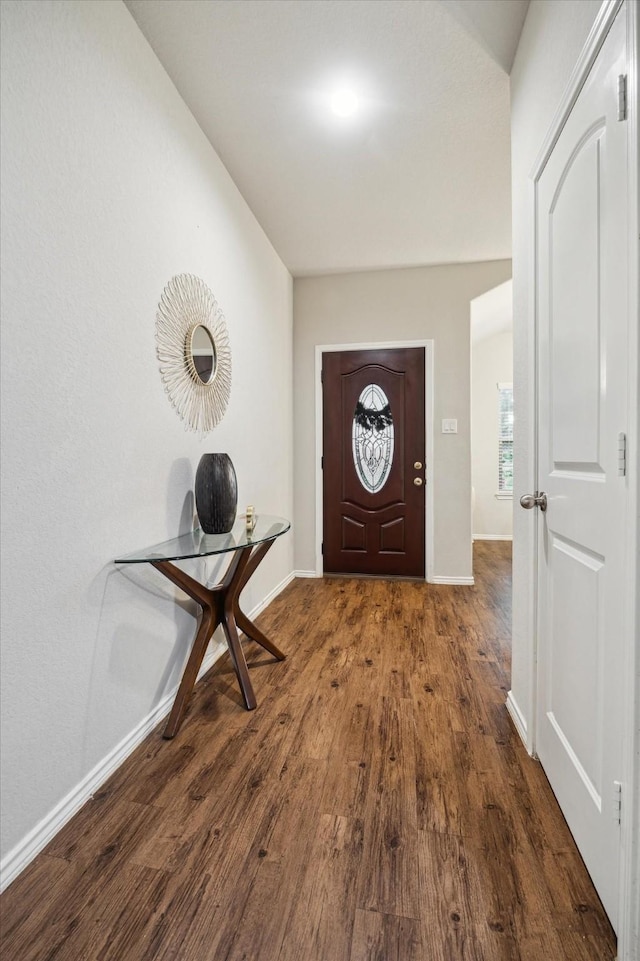 entryway featuring baseboards and wood finished floors