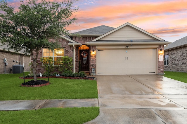 ranch-style home with brick siding, an attached garage, driveway, and a yard