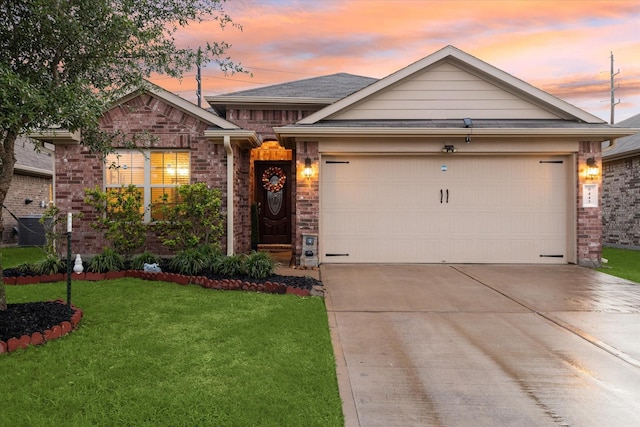 ranch-style home featuring an attached garage, brick siding, a yard, and concrete driveway