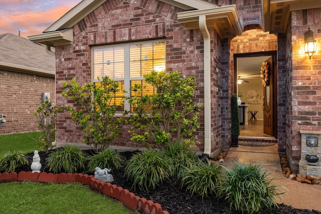 exterior entry at dusk with brick siding