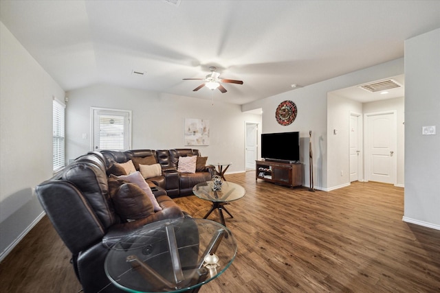 living room with baseboards, wood finished floors, visible vents, and a ceiling fan