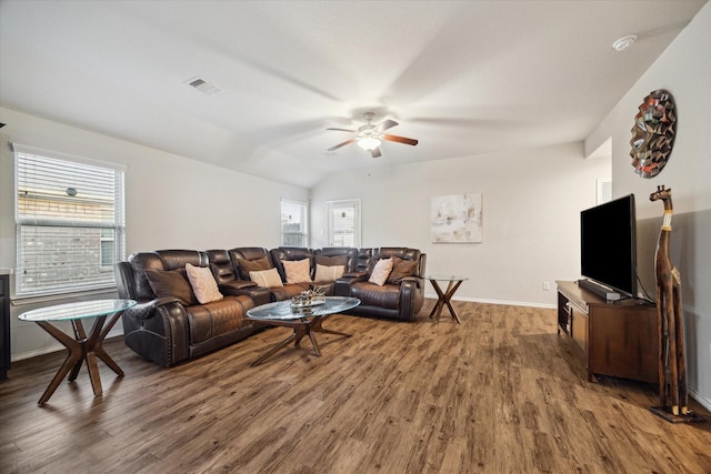 living room featuring visible vents, baseboards, wood finished floors, and ceiling fan