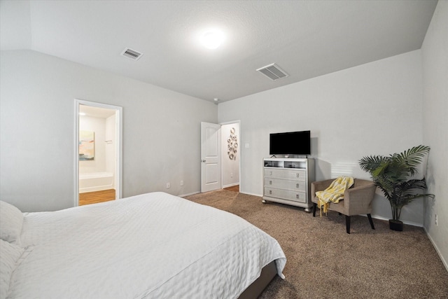 bedroom with visible vents, carpet flooring, baseboards, and ensuite bathroom