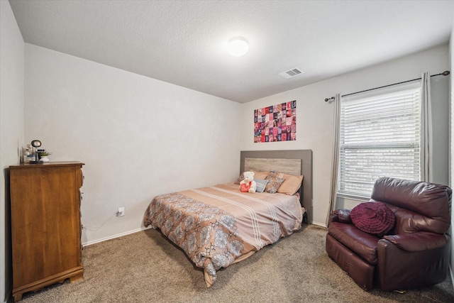 carpeted bedroom featuring baseboards and visible vents