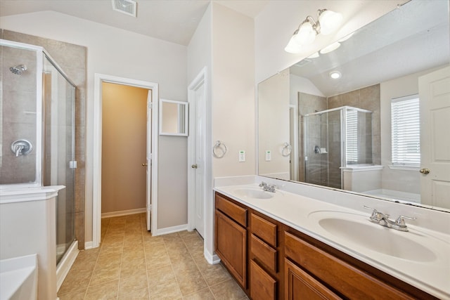 bathroom featuring lofted ceiling, visible vents, a stall shower, and a sink